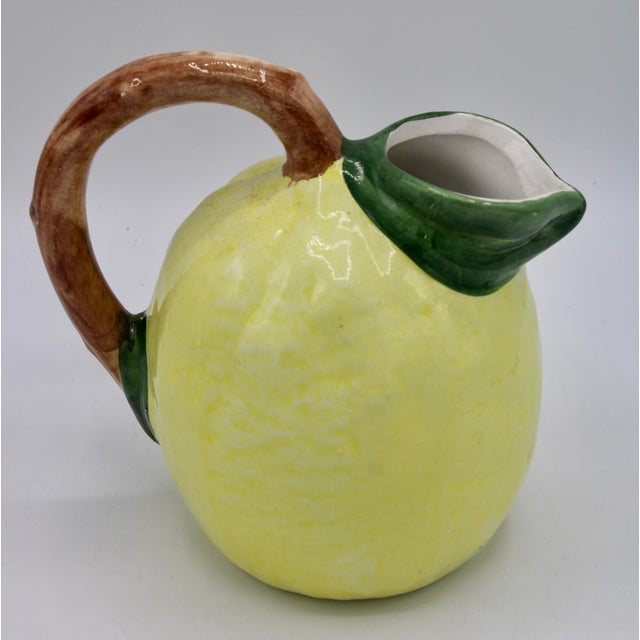 A charming 1960s vintage Italian lemon pitcher. It’s a lovely shade of bright light yellow with a green leaf like spout...