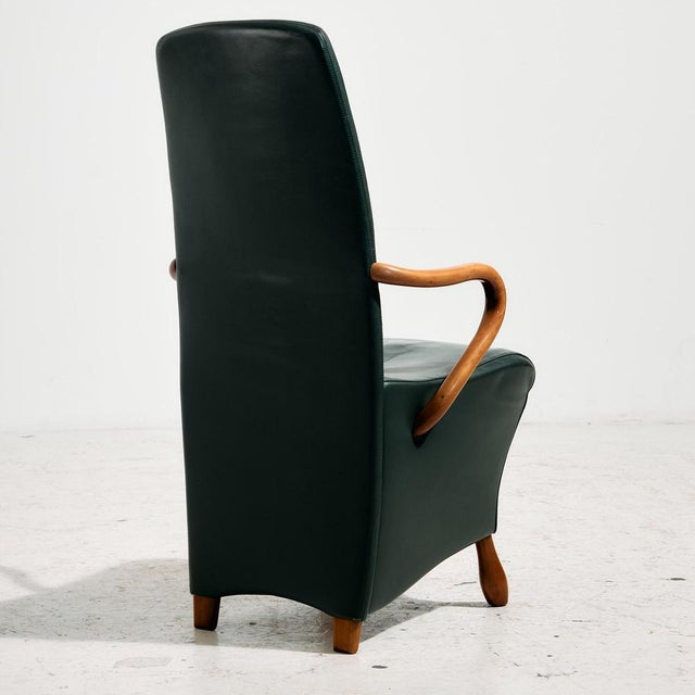 Italian armchair from the 1990s designed by Roberto Lazzeroni. The chair has elegant, soft shapes with beech armrests and...