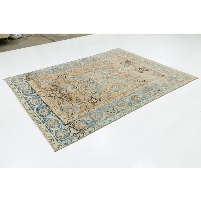 Discover the elegance of this antique Malayer hand-knotted wool rug, showcasing a rich tan backdrop adorned with a...