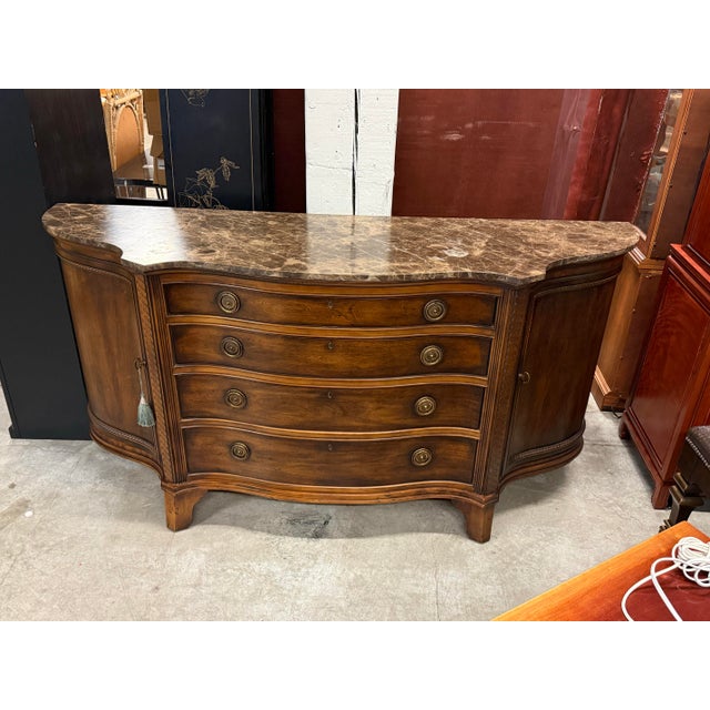 Design Plus Gallery presents a Century Furniture Marble-Top Serpentine Buffet. This case piece (40402M) has a shaped...
