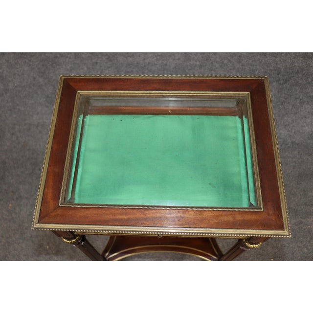An elegant and exceptionally refined antique French Louis XVI style table vitrine, masterfully crafted with fine mahogany...
