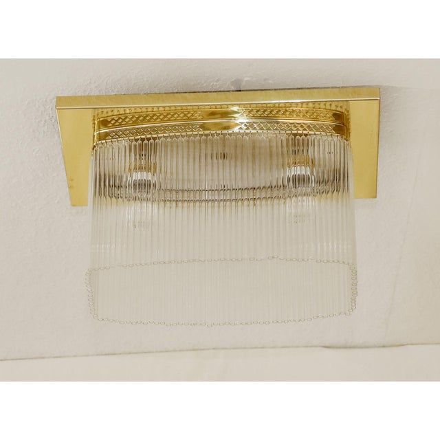 Art Nouveau ceiling lamp, circa 1915. Rectangular brass ceiling plate. The body features a lattice-like openwork design....
