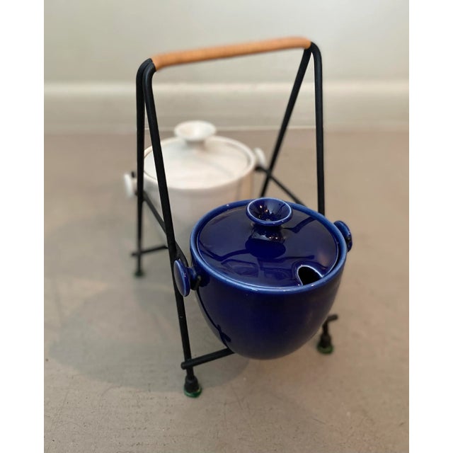 Rare mid-century modern Eslau Stoneware Denmark condiment set. Features one blue and one white covered jars that sit on...