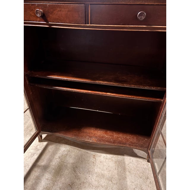 Very nice 1940's Maddox Furniture mahogany bookcase/cabinet with two ornate glass doors and two small storage drawers....
