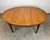 A beautiful Baker Furniture Federal / Regency style dining table on casters with inlaid walnut and three 18” leaves. Circa...