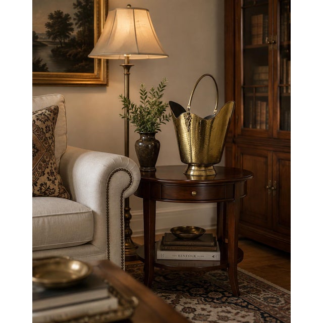 Elegant vintage coal scuttle or fireplace bucket crafted from hammered brass, featuring a tall arched carrying handle,...