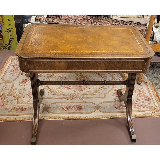 Fine early 20th century Georgian style leather top small writing desk. Features carmel color leather top with gilt trim...