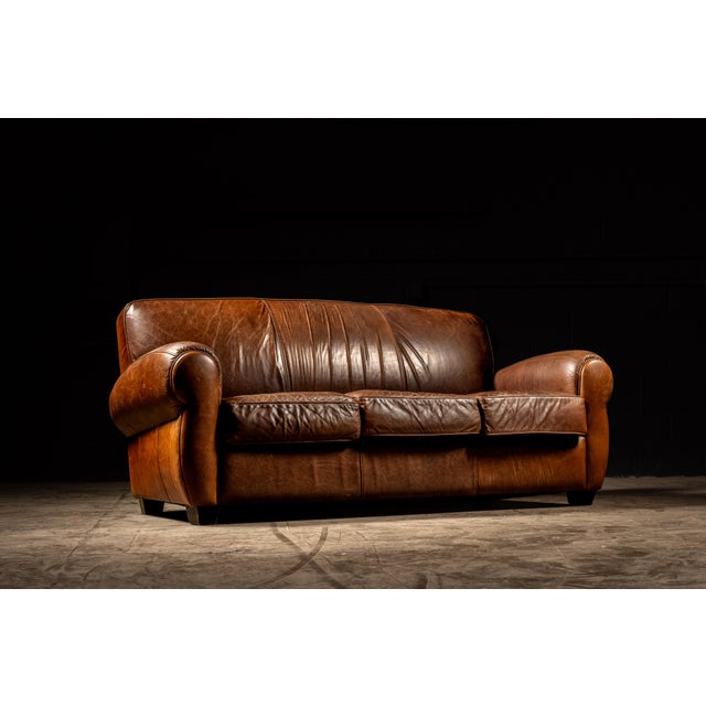 Worn leather in rich, warm brown gives this piece a comfortable and familiar look. Designed to make whoever is seated feel...
