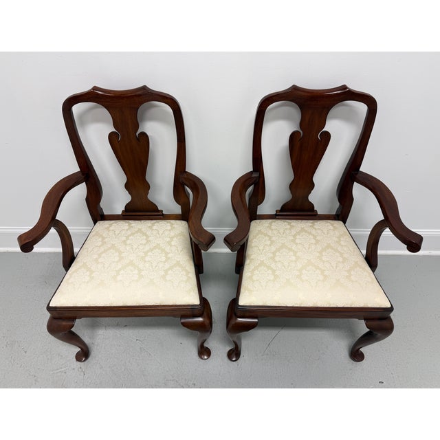 A pair of Queen Anne style dining armchairs by Henkel Harris of Winchester, Virginia, USA. Solid mahogany, carved crest...