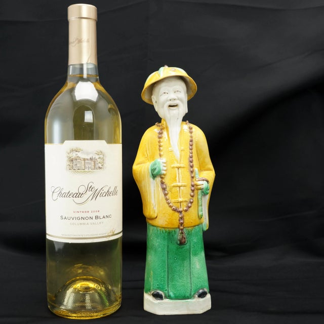 A colorful and sculptural figure of a Chinese Mandarin with much detail. The molded porcelain figure has been painted with...