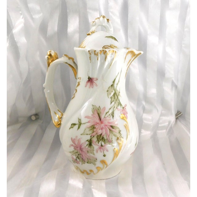 This is a white Jean Pouyat Limoges Chocolate or Teapot. The Jean Pouyat mark is dated 1890 to 1902. This pot has pink...