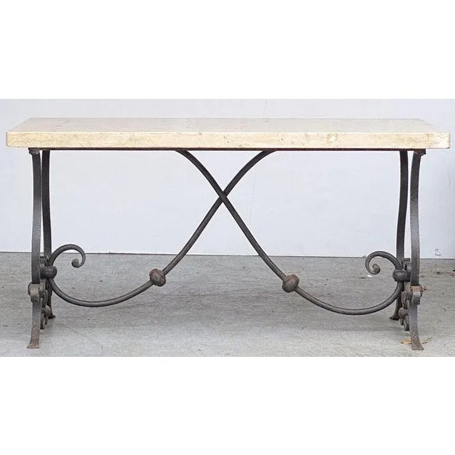 A fine French Mid-Century Modern low cocktail or coffee table featuring a rectangular figured marble top set upon a...