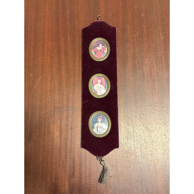 Design Plus Gallery presents a Vintage Three Miniature Portraits Velvet Wall Plaque. This decorative piece displays three...