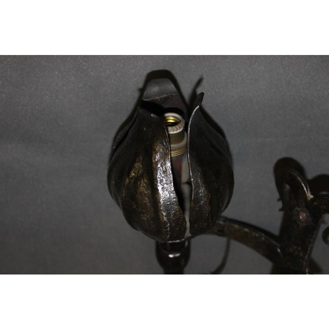 Set of six wrought iron wall sconces in the medieval style, signed Reboulet, with wiring in good condition, 20th century,...