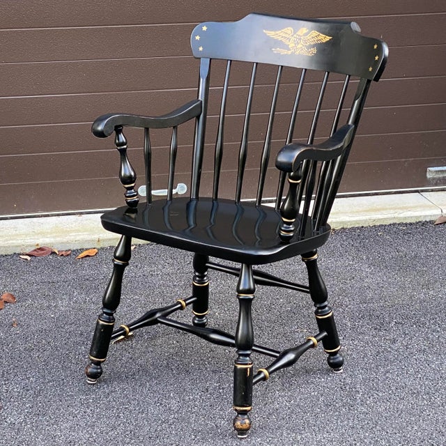 A vintage Ethan Allen Early American armchair with original black and gold painted finish over solid Maple and Birch.