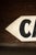 Single-sided hand-painted wooden sign in an arrow format, advertising nearby cabin lodging just a quarter mile ahead. Bold...