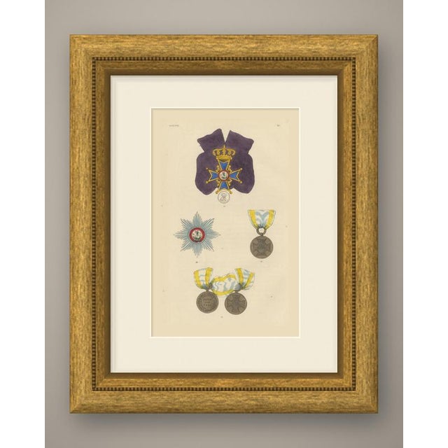This original antique wood engraving, colored by hand, shows insignia of hanover. At the top (11) a badge hangs from a...