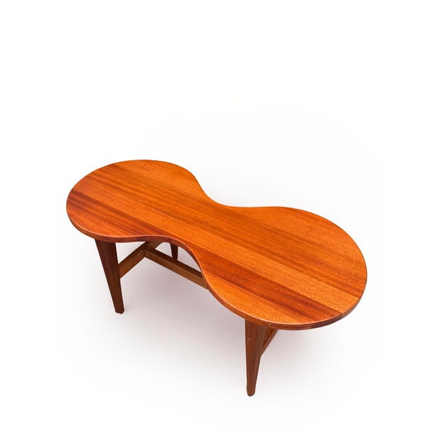 A rare and sculptural mid-century coffee table in solid teak, circa 1960, and a piece of considerable design merit. The...