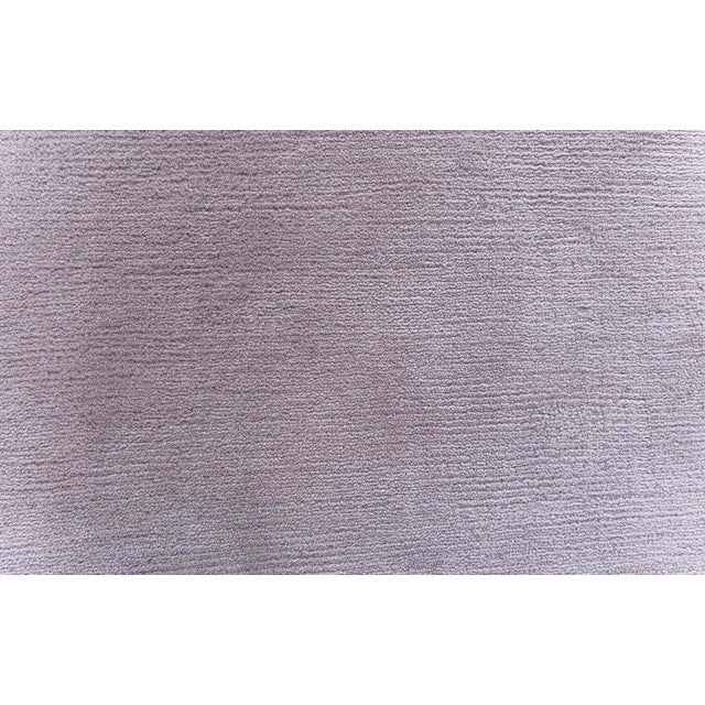 This contemporary hand-knotted wool rug embodies understated elegance through its refined simplicity and sophisticated...
