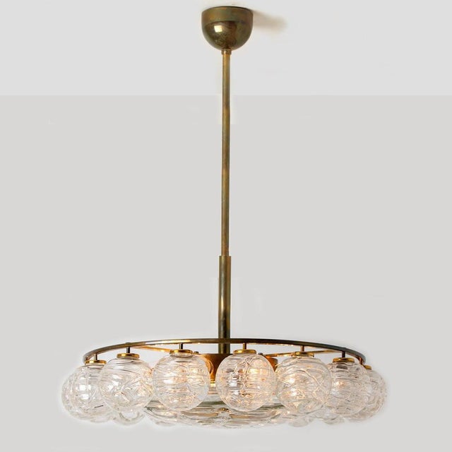 Beautiful chandelier with 16 small glass globes on a brass frame by doria leuchten, manufacturered in 1965. With 16 hand...