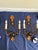 An authentic pair of Paul Ferrante Model 1000 two-light wall sconces, handcrafted from forged iron with hand-hammered...