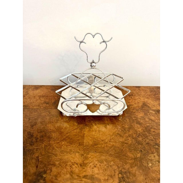 Antique Edwardian silver plated cruet set having a quality silver plated stand with a shaped handle to the middle with six...