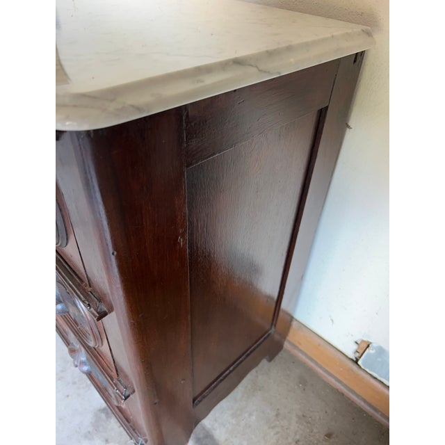 This is a walnut chest with removable marble top. It has a leaf design in the handles. The dark wood is rich in color and...