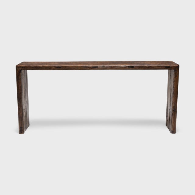 This reclaimed wood console table is a celebration of wabi-sabi style. The long table has a minimalist waterfall design,...