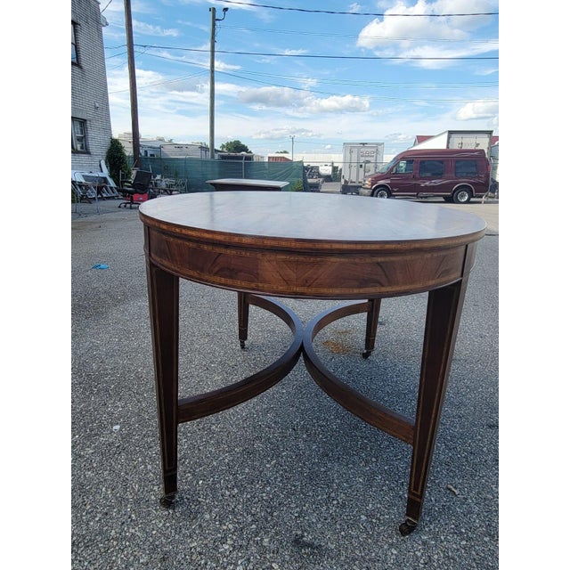 This English 19th century mahogany oval conference table is a beautifully crafted antique piece that exudes elegance and...