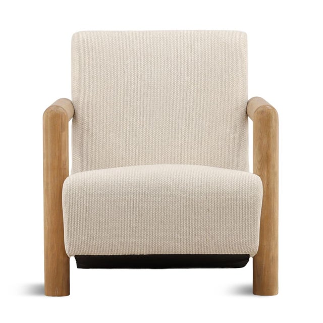 Structured yet soft lounge chair featuring a solid wood frame with clean, architectural lines paired with a richly...