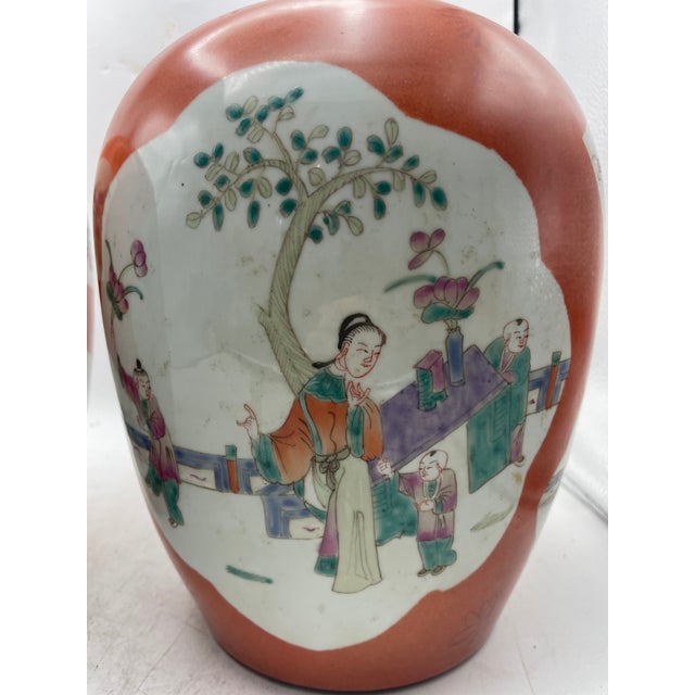 Lovely pair of hand painted Chinese Chinoiserie Ginger Jars. The pair are in a rare salmon color with multil color accents...