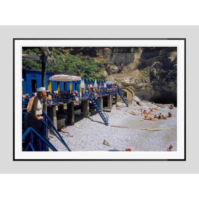 Capri Boat by Toni Frissell Beachgoers enjoy a beach club under a limestone mountain in Capri, 1959. (Toni Frissell)...