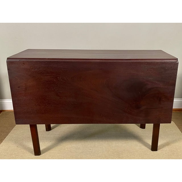 A Georgian drop-leaf gate-leg table, featuring solid mahogany Marlborough legs and a richly figured 3/4” solid mahogany...