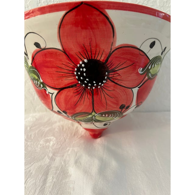 Vibrant vintage Mexican pottery hanging wall planter featuring a hand-painted glazed floral motif. Hole on back for...