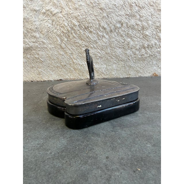 Art Deco silver plate lid with dog figurine on molded black glass container. This piece was manufactured by Weidlich...