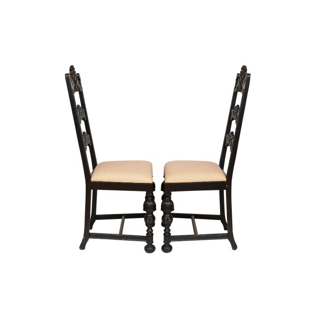 A pair of William & Mary ladderback side chairs. Tall chair backs are constructed with three cross rails elaborately...