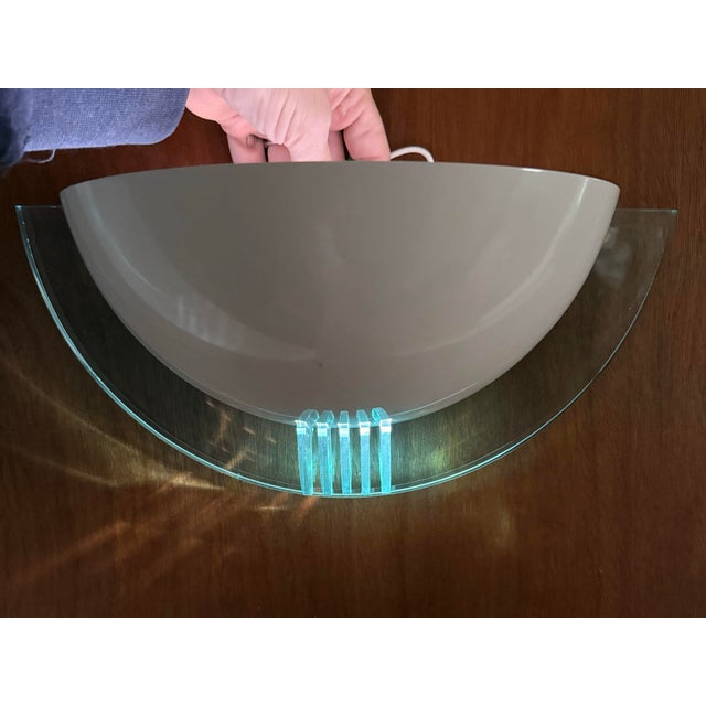 New old stock white metal postmodern sconce light fixture. Has an illuminated lucite plate and several illuminated lucite...