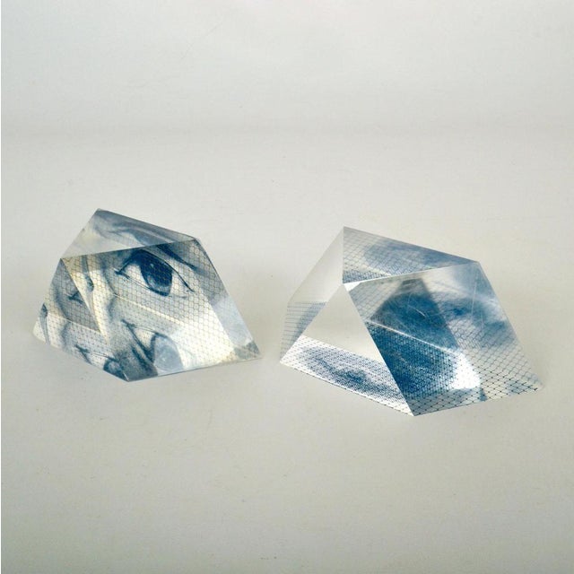 Surrealist paperweight sculptures have eyes screen printed on sharp cut acrylic shapes. The eyes reflect on the different...