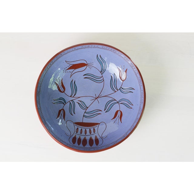 Vintage studio redware bowl featuring a lavender-blue interior and sgraffito tulip motif in the Pennsylvania Dutch...