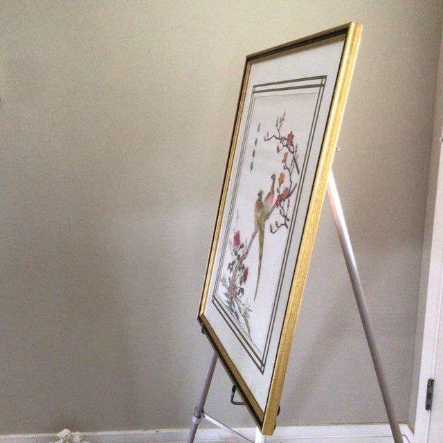 Colorful framed silk embroidered panel with fairy birds perched on peonies.