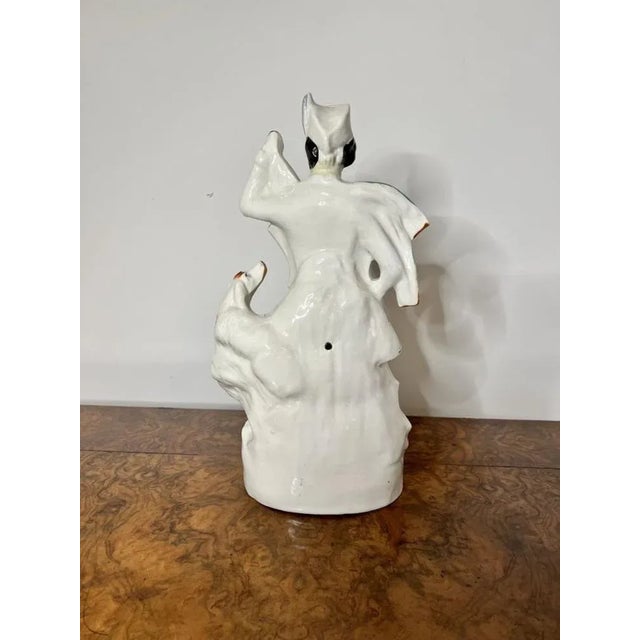 Unusual large antique Victorian Staffordshire figure of a Highlander in traditional clothing with his dog to his side...