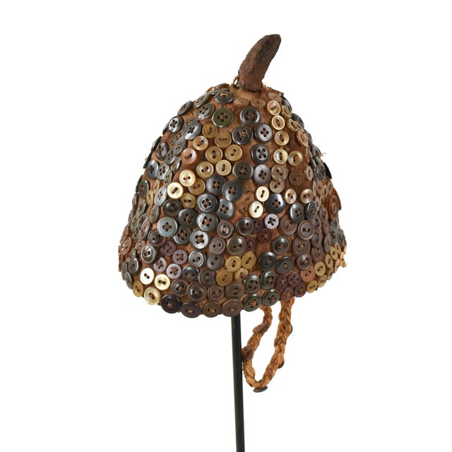 The Lega Bwami Society hat was crafted in the eastern regions of the Democratic Republic of Congo. This woven, palm fiber...
