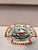 Square Majolica mermaid plate with shells on the corners, the mermaid sit on a flying fish, the border is decorated with...