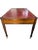 Late 18th century English writing table crafted in warm-toned wood, featuring a classic red leather top with gilt-tooled...