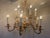 Exquisite vintage twelve light chandelier with its original prism swags. This gilt chandelier has a warm gold finish; and...