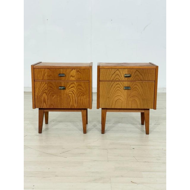 Beautiful pair of original vintage bedside tables in a timeless mid-century design. The cabinets impress with their...