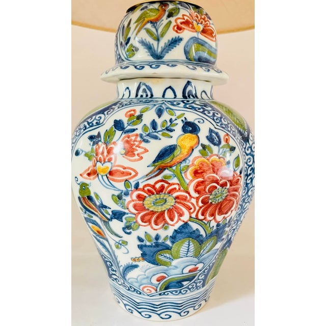 An early 20th century table lamp made from a rare antique lidded vase by royal tichelaar makkum. Decorated on an off white...