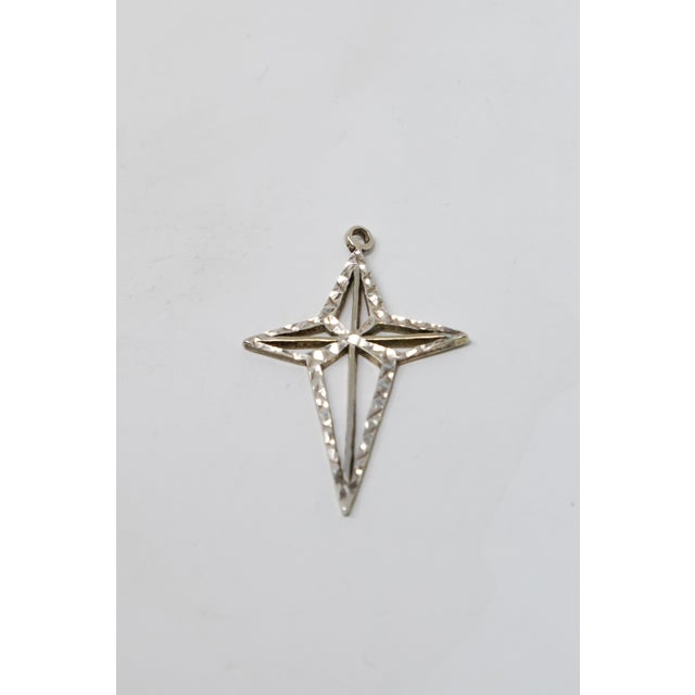 This gorgeous sterling Christmas star ornament will dazzle any eye. Openwork cross design and texture make this star...