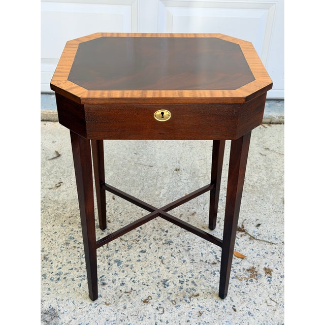Beautifully crafted Georgian side table made of flame mahogany with satinwood banding. Lift top, cross stretcher and...
