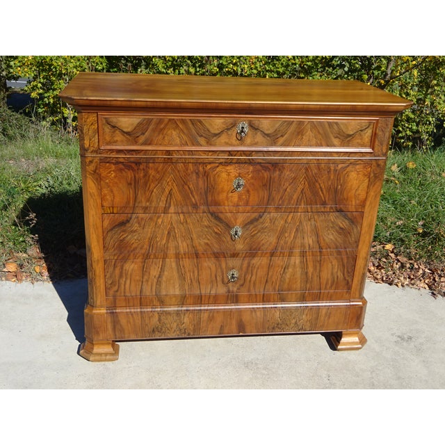 Large French-made chest of drawers, late 19th century. Solid wood frame, walnut top and sides. The front is entirely...
